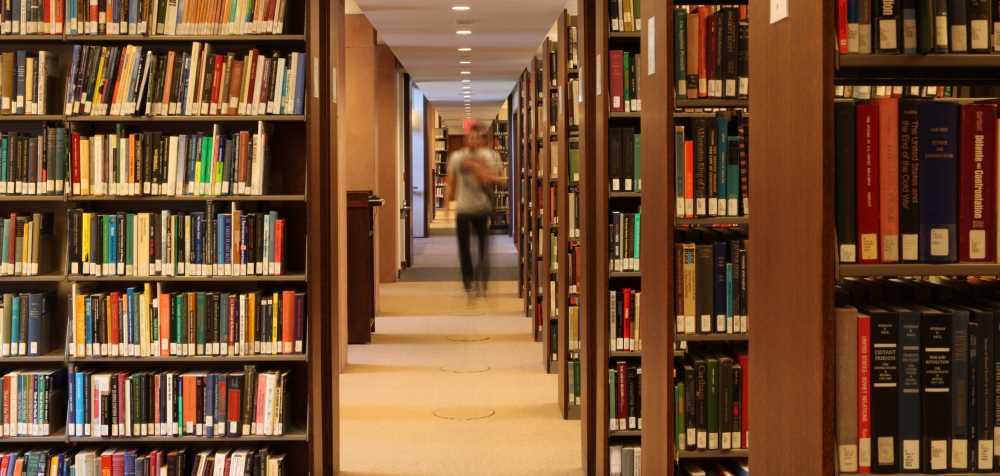 Student in the Graham Library Stacks